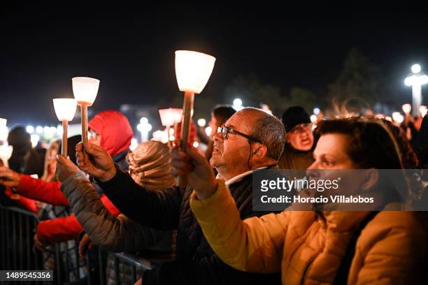 Pilgrims and members of the faithful participate in the Rosary and the Candles Procession at the end of the first day ceremonies of the two-day...