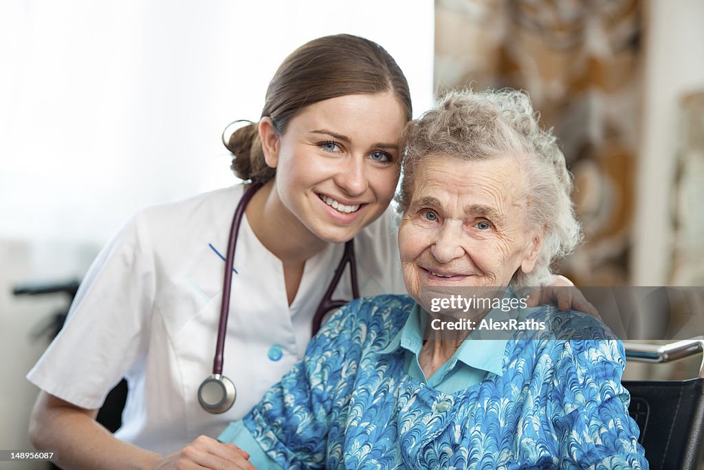 Elderly women posing with a nurse