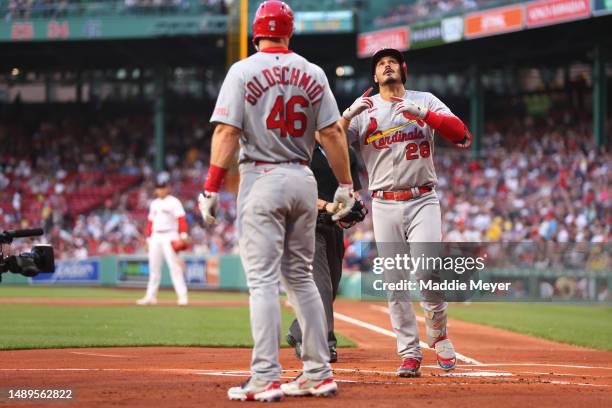 Nolan Arenado of the St. Louis Cardinals celebrates with Paul Goldschmidt after hitting a two run home run against the Boston Red Sox during the...