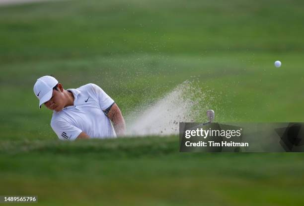 Tom Kim of South Korea plays a shot from a bunker on the 14th hole during the second round of the AT&T Byron Nelson at TPC Craig Ranch on May 12,...