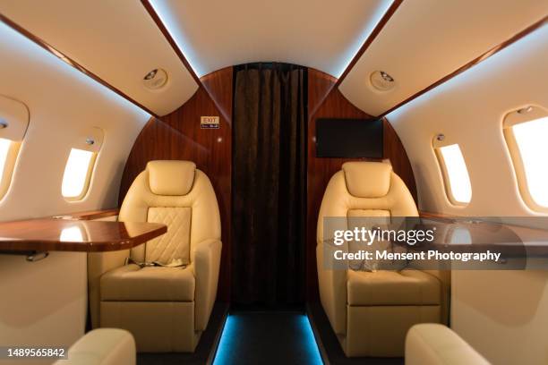 interior of empty luxury airplane passenger cabin - vip travel stock pictures, royalty-free photos & images