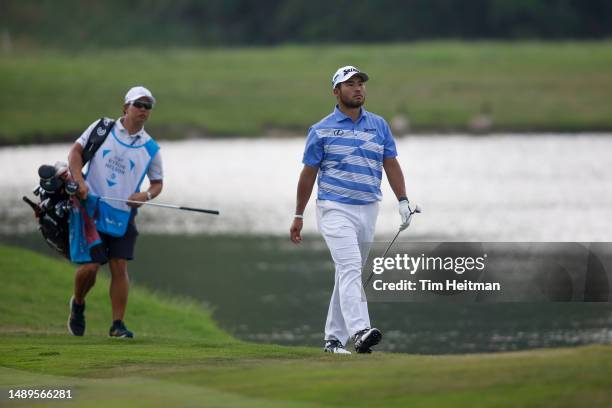 Hideki Matsuyama of Japan walks with caddie Shota Hayafuji up the 14th hole during the second round of the AT&T Byron Nelson at TPC Craig Ranch on...