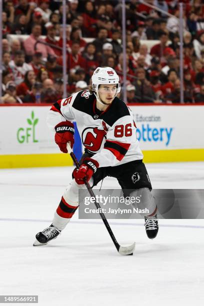 Jack Hughes of the New Jersey Devils skates with the puck against Carolina Hurricanes during the second period of Eastern Conference Game Five of the...