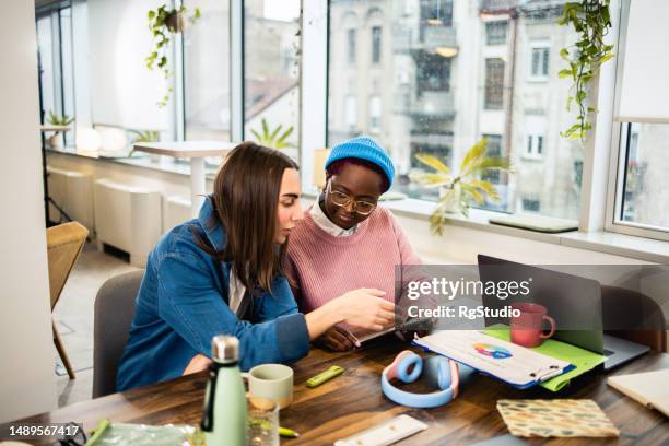 three young colleagues cooperating on their work - androgynous stock pictures, royalty-free photos & images