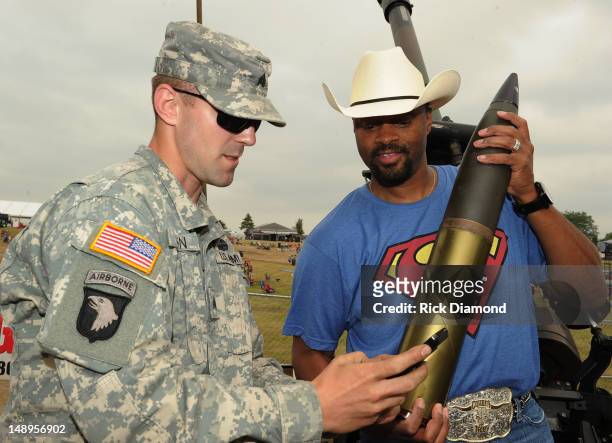 Recording Artist Cowboy Troy fires a Howitzer 105mm cannon with the help of the Wisconsin National Guard at Country Thunder - Day 1 on July 19, 2012...