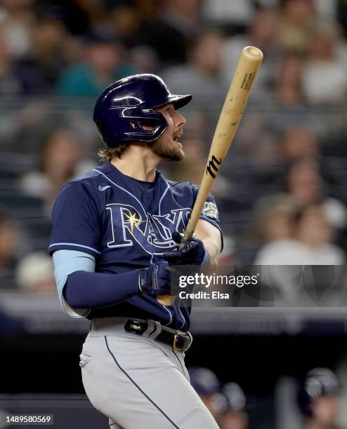 Josh Lowe of the Tampa Bay Rays reacts as he watches his hit become a three run home run in the eighth inning against the New York Yankees at Yankee...