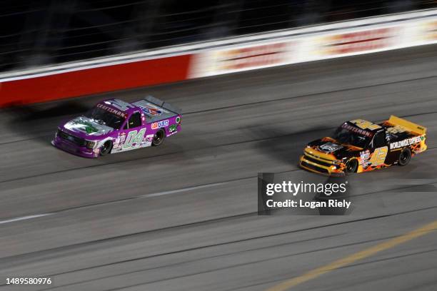 Carson Hocevar, driver of the Worldwide Express Chevrolet, and Johnny Sauter, driver of the CarQuest/Roper Racing Ford, race during the NASCAR...