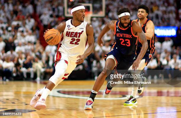 Jimmy Butler of the Miami Heat drives on Mitchell Robinson of the New York Knicks during game six of the Eastern Conference Semifinals in the 2023...