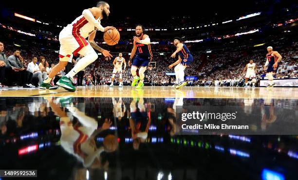 Caleb Martin of the Miami Heat drives on Jalen Brunson of the New York Knicks during game six of the Eastern Conference Semifinals in the 2023 NBA...
