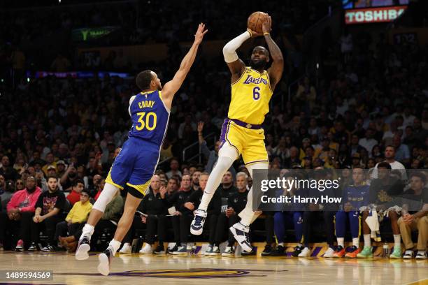 LeBron James of the Los Angeles Lakers shoots the ball over Stephen Curry of the Golden State Warriors during the first quarter in game six of the...