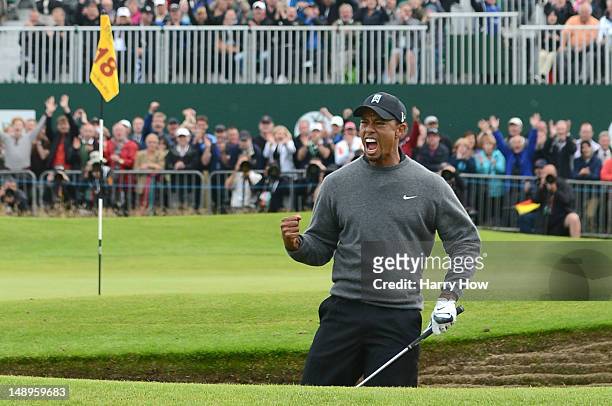 Tiger Woods of the United States celebrates after holing out from a bunker for birdie on the 18th hole during the second round of the 141st Open...