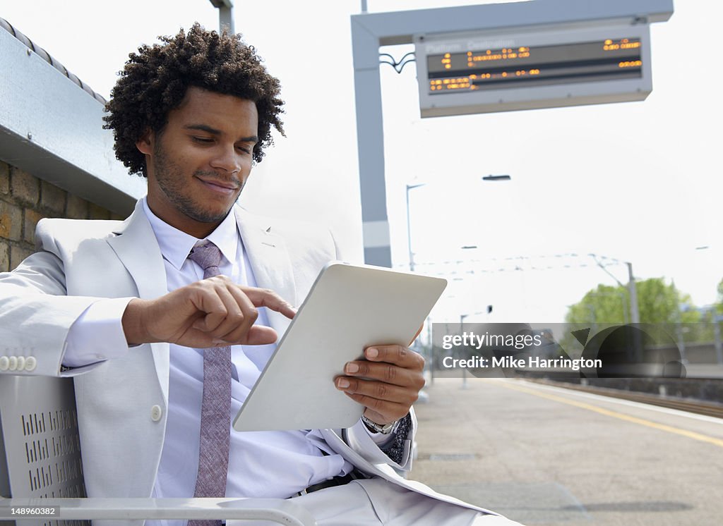 Business Man Sitting at Station Using tablet computer