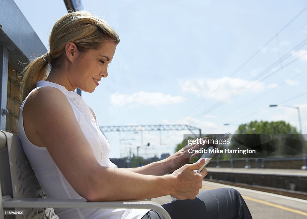 Female Using tablet computer at Train Station