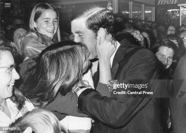 Prince Charles receives a kiss from sixteen year-old Gilda Larbey during a walkabout in the Mall, Perth, Western Australia, 10th November 1977. The...