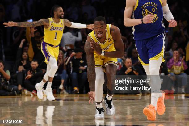 Lonnie Walker IV of the Los Angeles Lakers celebrates his three point basket next to Donte DiVincenzo of the Golden State Warriors during the third...