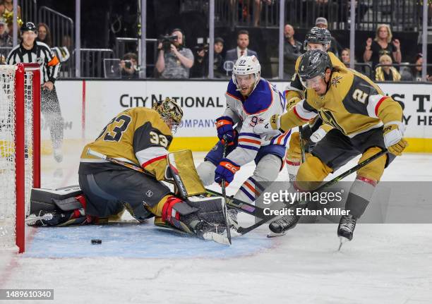 Connor McDavid of the Edmonton Oilers scores a third-period power-play goal against Adin Hill, Zach Whitecloud and Brayden McNabb of the Vegas Golden...