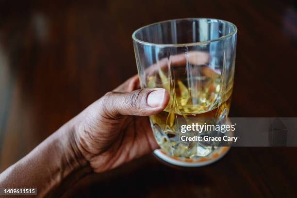 woman drinks cold beverage at table - apple juice stock pictures, royalty-free photos & images