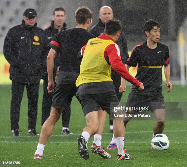 Sir Alex Ferguson watches Shinji Kagawa of Manchester United in action during a first team training session as part of their pre-season tour of South...