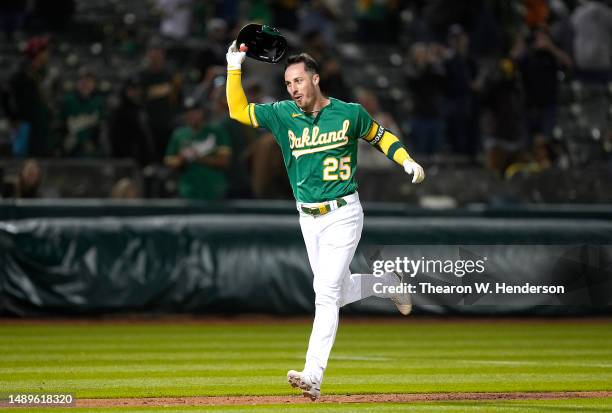 Brent Rooker of the Oakland Athletics trots around the bases and celebrates after hitting a walk-off three-run home run to defeat the Texas Rangers...