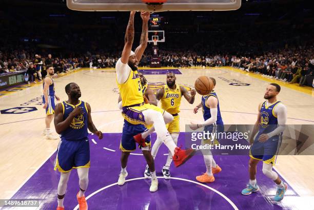 Anthony Davis of the Los Angeles Lakers dunks past Draymond Green of the Golden State Warriors during the third quarter in game six of the Western...
