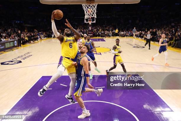 LeBron James of the Los Angeles Lakers attempts a layup against Klay Thompson of the Golden State Warriors during the third quarter in game six of...