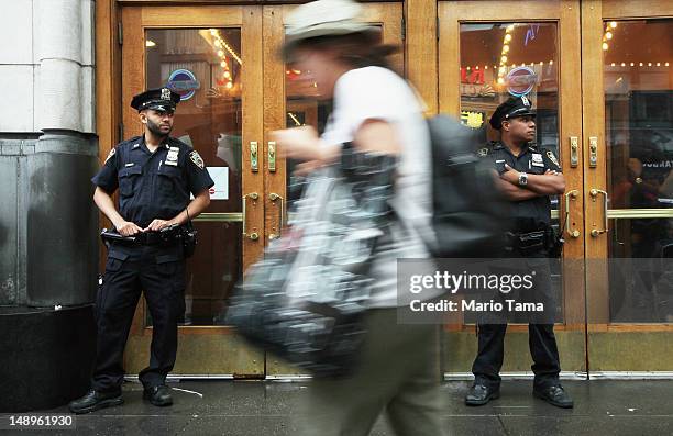 Officers keep watch in front of an AMC move theater where the film 'The Dark Knight Rises' is playing in Times Square on July 20, 2012 in New York...