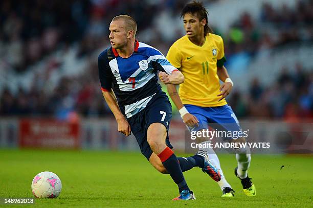 Great Britain midfielder Tom Cleverley vies for the ball with Brazilian forward Neymar during the London 2012 Olympic games warm up football match...