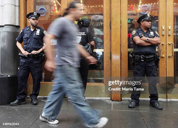 Officers keep watch in front of an AMC move theater where the film 'The Dark Knight Rises' is playing in Times Square on July 20, 2012 in New York...