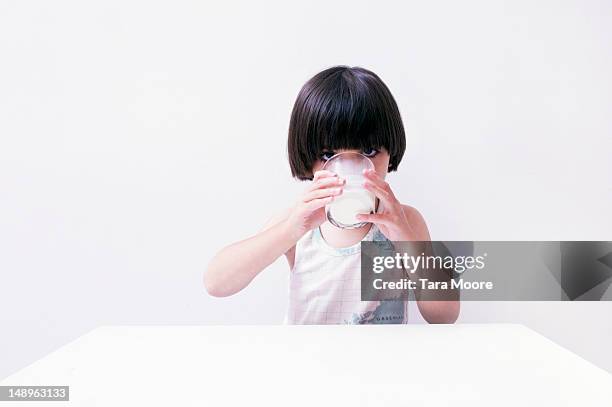 young child drinking glass of milk - table stock pictures, royalty-free photos & images