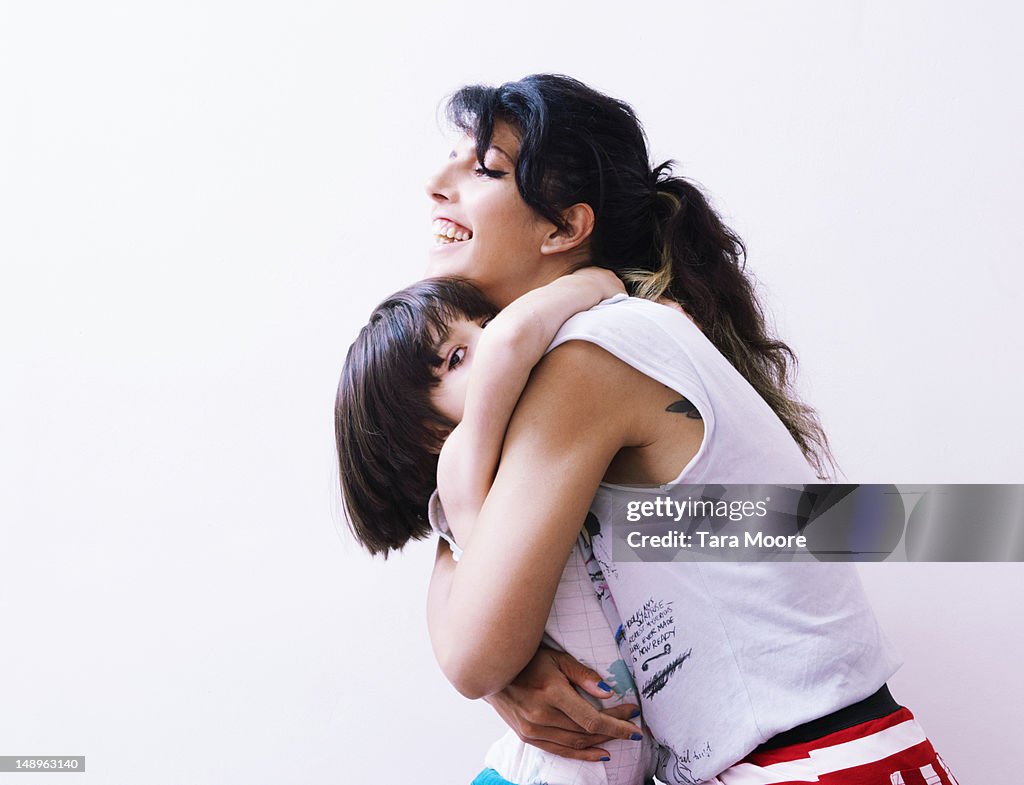 Mother and child hugging with white background