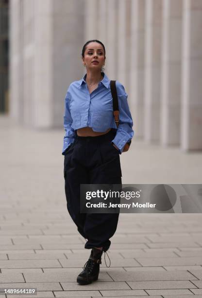 Tara Tut seen wearing Louis Vuitton black logo high boots, Louis Vuitton vintage logo backpack, Zara cropped pinstripes blue blouse and Zara...