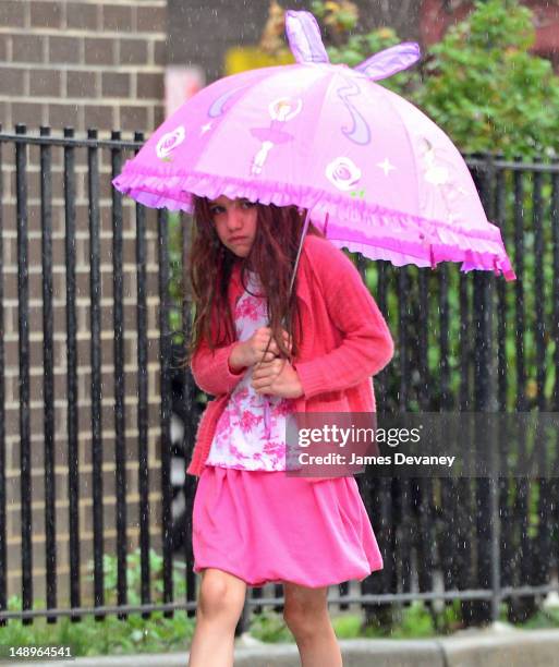 Suri Cruise seen walking in the rain in Chelsea on July 20, 2012 in New York City.