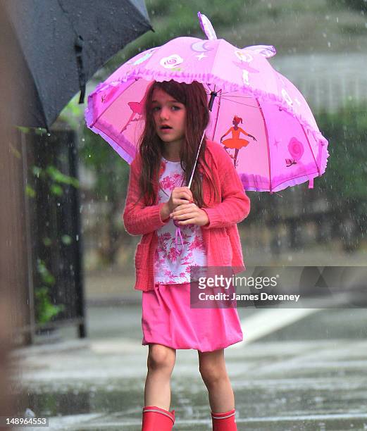 Suri Cruise seen walking in the rain in Chelsea on July 20, 2012 in New York City.
