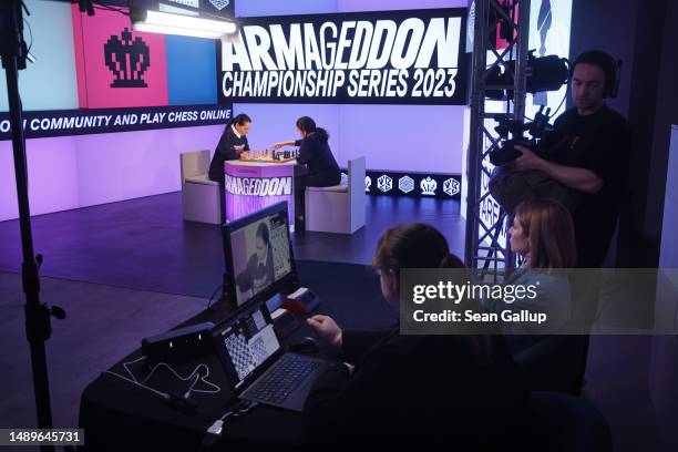 Chess grandmasters Alexandra Kosteniuk and Koneru Humpy face off during the women's week of the Armageddon Championship Series as employees monitor...