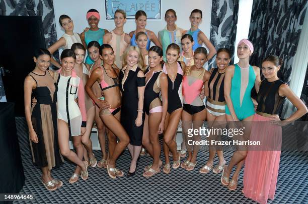 Designer Kelly Carrington poses with models at the Éclairée Presentation during Mercedes-Benz Fashion Week Swim 2013 at The Raleigh on July 20, 2012...