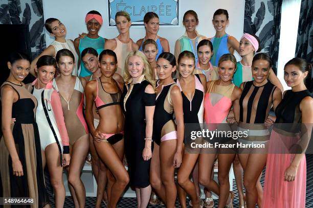 Designer Kelly Carrington poses with models at the Éclairée Presentation during Mercedes-Benz Fashion Week Swim 2013 at The Raleigh on July 20, 2012...