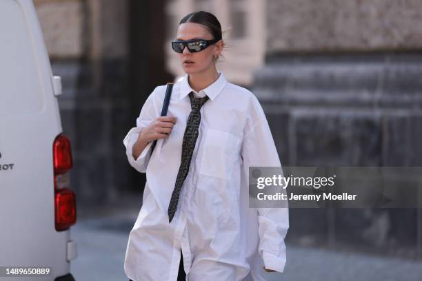 Alessa Winter seen wearing Nubikk black leather boots, YSL black leather golden logo bag, Fendi brown logo tie, Bottega Veneta black and silver...