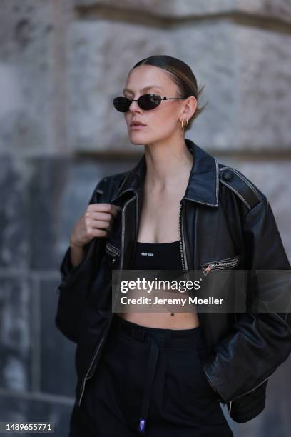 Alessa Winter seen wearing Miu Miu black logo bra top, Source Unknown biker black leather jacket, The North Face black cotton shorts, Gucci small...