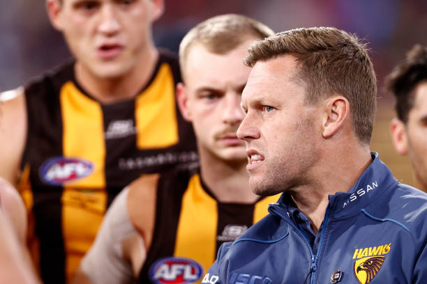 Sam Mitchell, coach of the Hawks speaks to his players during the round nine AFL match between Hawthorn Hawks and Melbourne Demons at Melbourne...