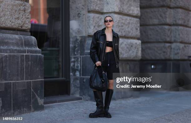 Alessa Winter seen wearing Miu Miu black logo bra top, Source Unknown biker black leather jacket, The North Face black cotton shorts, Gucci small...