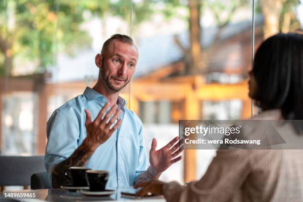 two adult people talk relaxing while taking a break the coffeehouses, cafe society communication of the city life for the social gathering, relax, networking, meeting and discussion for business - succession planning stock pictures, royalty-free photos & images
