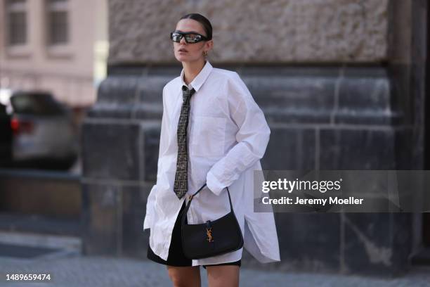 Alessa Winter seen wearing Nubikk black leather boots, YSL black leather golden logo bag, Fendi brown logo tie, Bottega Veneta black and silver...