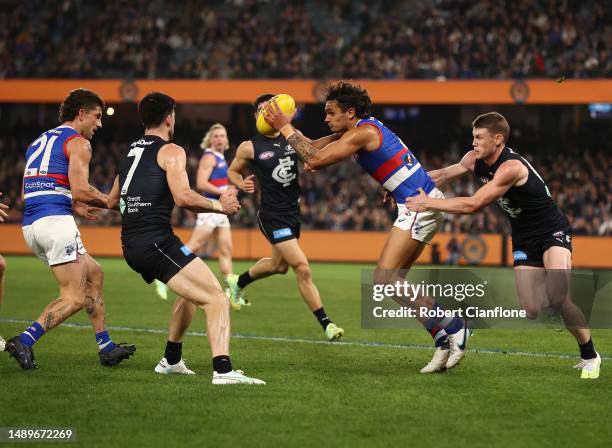 Jamarra Ugle-Hagan of the Bulldogs is challenged by Sam Walsh of the Blues during the round nine AFL match between Carlton Blues and Western Bulldogs...