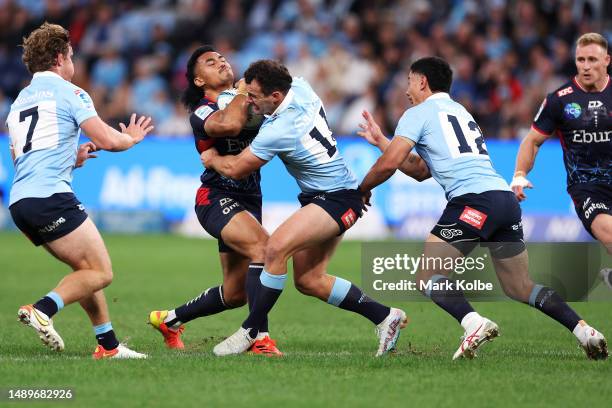 David Feliuai of the Rebels is tackled by Dylan Pietsch of the Waratahs during the round 12 Super Rugby Pacific match between NSW Waratahs and...