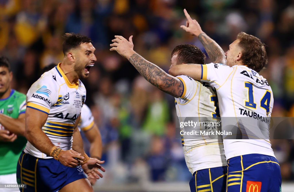 Nolan Stringer J'maine Hopgood of the Eels celebrates scoring a try with team mates ...