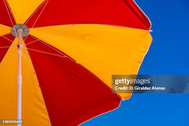 beach umbrella on the beach. - parasol stock pictures, royalty-free photos & images