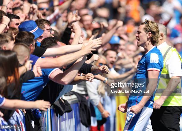 Todd Cantwell of Rangers FC celebrates with the fans after scoring the team's first goal during the Cinch Premiership match between Rangers and...