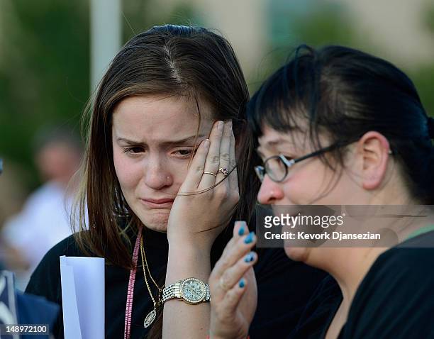 Dara Anderson and Monique Anderson cry during a candelight vigil on July 20, 2012 in Denver, Colorado. The vigil took place across the street from...