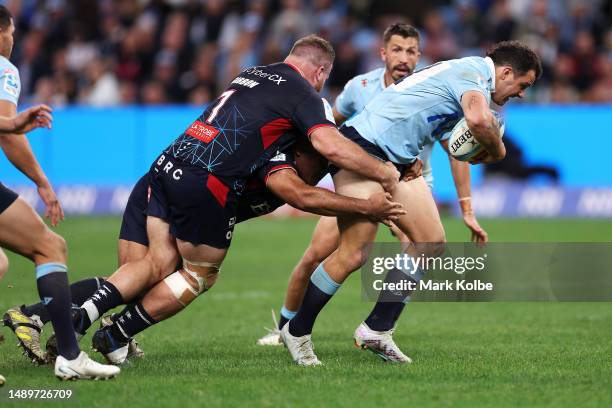 Dylan Pietsch of the Waratahs is tackled during the round 12 Super Rugby Pacific match between NSW Waratahs and Melbourne Rebels at Allianz Stadium,...