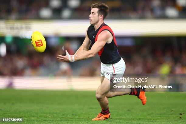 Zach Merrett of the Bombers handballs during the round nine AFL match between Brisbane Lions and Essendon Bombers at The Gabba, on May 13 in...